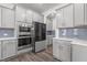 Sleek kitchen design featuring stainless steel appliances, grey cabinetry, and a modern aesthetic at 1414 Arena Ln, Fuquay Varina, NC 27526