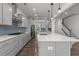 Modern kitchen with stainless steel appliances, a large island, and stylish pendant lights at 1414 Arena Ln, Fuquay Varina, NC 27526