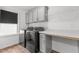 Functional laundry room with modern washer and dryer, countertop space, and upper cabinets at 1414 Arena Ln, Fuquay Varina, NC 27526