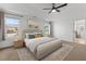 Bright main bedroom boasts tray ceiling, a ceiling fan and large windows at 1414 Arena Ln, Fuquay Varina, NC 27526