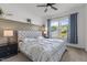 Cozy main bedroom with a large window providing a view of the backyard and neighborhood at 1414 Arena Ln, Fuquay Varina, NC 27526