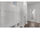 Well-organized mudroom with wainscoting, coat hooks, bench seating, and access to bathroom at 1414 Arena Ln, Fuquay Varina, NC 27526