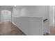 Upstairs hallway with hardwood floors providing access to bedrooms and bathrooms at 1414 Arena Ln, Fuquay Varina, NC 27526