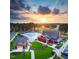 Aerial view showcases a resort style community pool and amenity center set among lush trees and landscaping at 152 Serene Xing, Fuquay Varina, NC 27526