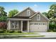 Charming single Gathering home with neutral colors, lovely curb appeal, two car garage and manicured front yard at 152 Serene Xing, Fuquay Varina, NC 27526