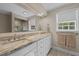 Bathroom with a large mirror, a double sink vanity, and a view into the shower at 1732 Edgewood Ave, Burlington, NC 27215