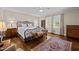 Traditional bedroom featuring hardwood floors, a patterned rug, and neutral paint at 1732 Edgewood Ave, Burlington, NC 27215