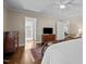 Bedroom featuring hardwood floors and a view into an ensuite bathroom at 1732 Edgewood Ave, Burlington, NC 27215