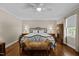 Bedroom with a bed, bench, wardrobe, hardwood floors and soft, natural light at 1732 Edgewood Ave, Burlington, NC 27215