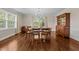 Elegant dining room featuring hardwood floors, large windows, and a classic chandelier at 1732 Edgewood Ave, Burlington, NC 27215