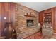 Living room with beautiful brick fireplace and wooden accents with a red patterned rug at 1732 Edgewood Ave, Burlington, NC 27215