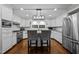 Modern kitchen with white cabinets, granite countertops, stainless steel appliances, and hardwood floors at 1732 Edgewood Ave, Burlington, NC 27215