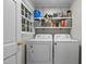 Laundry room features a pair of white washing machines, shelves, and storage solutions at 1732 Edgewood Ave, Burlington, NC 27215