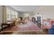 Bright living room featuring hardwood floors, a fireplace, and a large window overlooking the yard at 1732 Edgewood Ave, Burlington, NC 27215