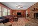 Inviting living room features a fireplace, wood paneling, and a large window overlooking the backyard at 1732 Edgewood Ave, Burlington, NC 27215