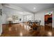 Bright living room boasts hardwood floors and neutral colors with a doorway to a carpeted room at 1732 Edgewood Ave, Burlington, NC 27215