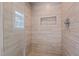 Walk-in shower featuring beige tiling and a built-in niche at 1732 Edgewood Ave, Burlington, NC 27215