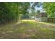 The wide open backyard is bordered by trees and fencing at 178 Palmer Dr, Clayton, NC 27527