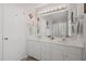 Bathroom with white cabinets and a mirror with vanity lights above dual sinks at 178 Palmer Dr, Clayton, NC 27527
