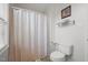 Cozy bathroom featuring a toilet, framed art, and neutral beige striped shower curtain at 178 Palmer Dr, Clayton, NC 27527