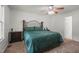 Cozy bedroom with a queen-sized bed, ceiling fan, and carpeted floors at 178 Palmer Dr, Clayton, NC 27527