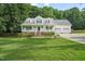 Charming two-story home featuring a spacious front porch and well-manicured lawn at 178 Palmer Dr, Clayton, NC 27527