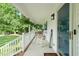 Relaxing front porch with a rocking chair, porch swing and hanging plants at 178 Palmer Dr, Clayton, NC 27527