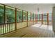 Spacious screened-in porch with wood flooring and lots of natural light at 178 Palmer Dr, Clayton, NC 27527