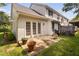 Spacious backyard with concrete patio, lush green lawn, and french doors at 2 Lake Village Dr, Durham, NC 27713