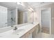 Well-lit bathroom features a double sink vanity, a walk-in shower, and extra storage space at 2 Lake Village Dr, Durham, NC 27713