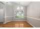 Bright dining room with vaulted ceiling, charming chandelier, and lovely hardwood floors at 2 Lake Village Dr, Durham, NC 27713