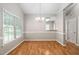 Bright dining room featuring hardwood floors, large window and attractive chandelier at 2 Lake Village Dr, Durham, NC 27713
