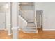 Inviting foyer with hardwood floors, elegant staircase, and natural light at 2 Lake Village Dr, Durham, NC 27713