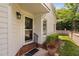 Charming front entrance with a storm door, brick steps and neatly kept landscaping at 2 Lake Village Dr, Durham, NC 27713