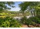 Picturesque lake view framed by lush trees and greenery at 2 Lake Village Dr, Durham, NC 27713