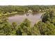 Scenic lake view surrounded by mature trees and lush foliage at 2 Lake Village Dr, Durham, NC 27713