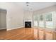 Bright living room with hardwood floors, a fireplace, and french doors to the exterior at 2 Lake Village Dr, Durham, NC 27713