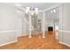 Open-concept floor plan with hardwood floors connecting the living and dining areas at 2 Lake Village Dr, Durham, NC 27713