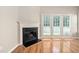 Cozy living room featuring a fireplace and French doors leading to a patio at 2 Lake Village Dr, Durham, NC 27713