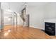Inviting living room featuring a fireplace, hardwood floors, and stairway to the second floor at 2 Lake Village Dr, Durham, NC 27713
