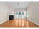 Spacious living room with hardwood floors, fireplace, and bright windows at 2 Lake Village Dr, Durham, NC 27713