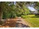 Scenic walking path leading to a glimpse of the lake and lush greenery at 2 Lake Village Dr, Durham, NC 27713