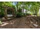 Backyard features a wooden swing set and a mulched walking path, creating a cozy and inviting outdoor space at 200 Frenchmans Bluff Dr, Cary, NC 27513