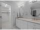 Elegant bathroom with double sinks, marble countertop and flooring with a view into closet at 200 Frenchmans Bluff Dr, Cary, NC 27513