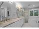 Bathroom featuring a double vanity, glass shower, soaking tub, and natural light at 200 Frenchmans Bluff Dr, Cary, NC 27513