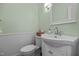 Cozy half bath with a white vanity, modern faucet, and tasteful decor, optimizing space and functionality at 200 Frenchmans Bluff Dr, Cary, NC 27513