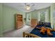 Bedroom features light green walls, carpeted floors, and natural lighting at 200 Frenchmans Bluff Dr, Cary, NC 27513