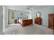 Bright bedroom with wood furniture, carpeted floor, two windows and a ceiling fan at 200 Frenchmans Bluff Dr, Cary, NC 27513