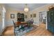 Elegant dining area with a wood table, hutch, and view into the kitchen, creating a welcoming ambiance at 200 Frenchmans Bluff Dr, Cary, NC 27513