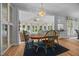 Inviting dining area with hardwood floors and a chandelier, flowing into a bright sunroom at 200 Frenchmans Bluff Dr, Cary, NC 27513